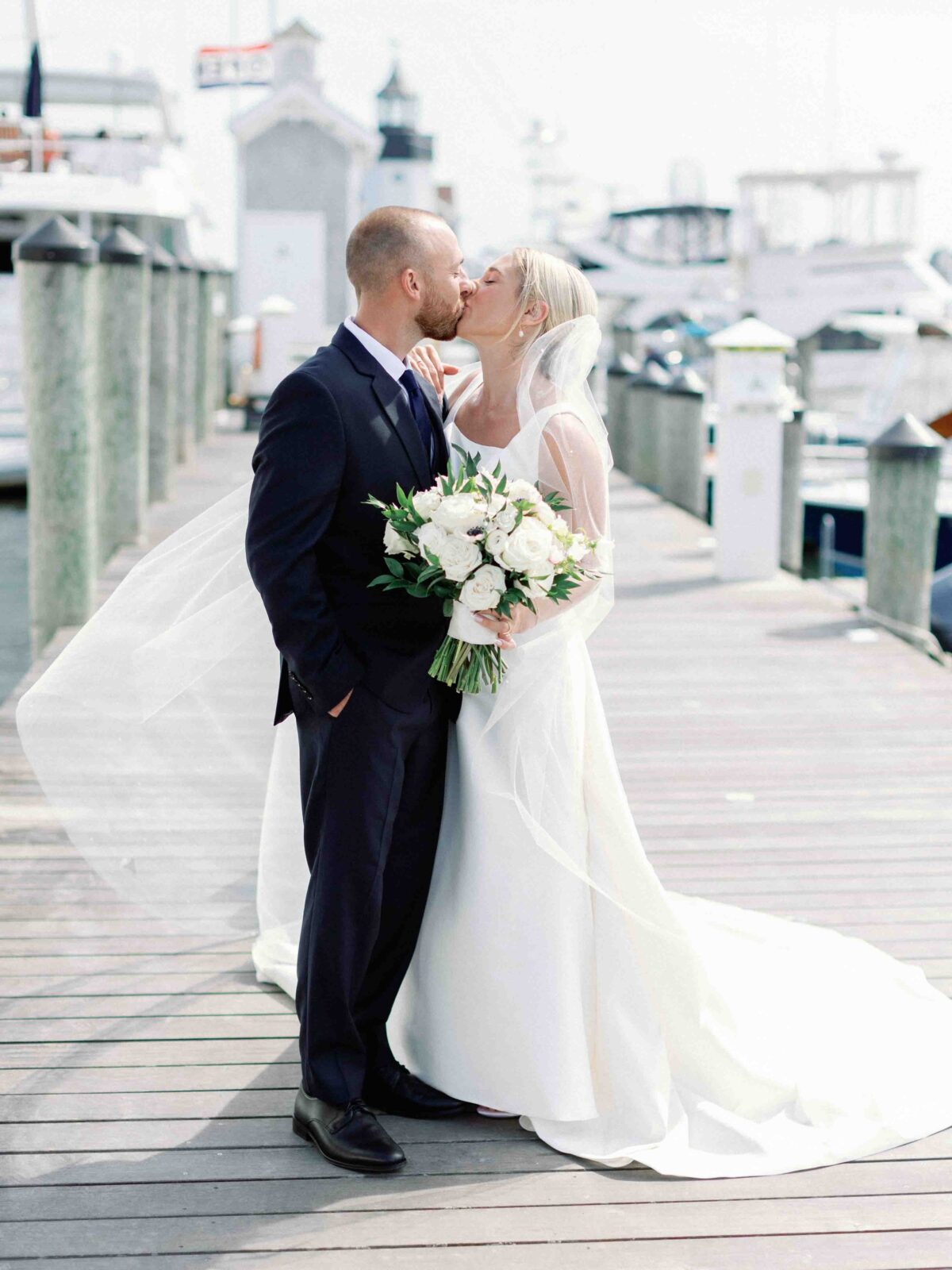 bride and groom on the docks of Saybrook Point Resort after their first look.
