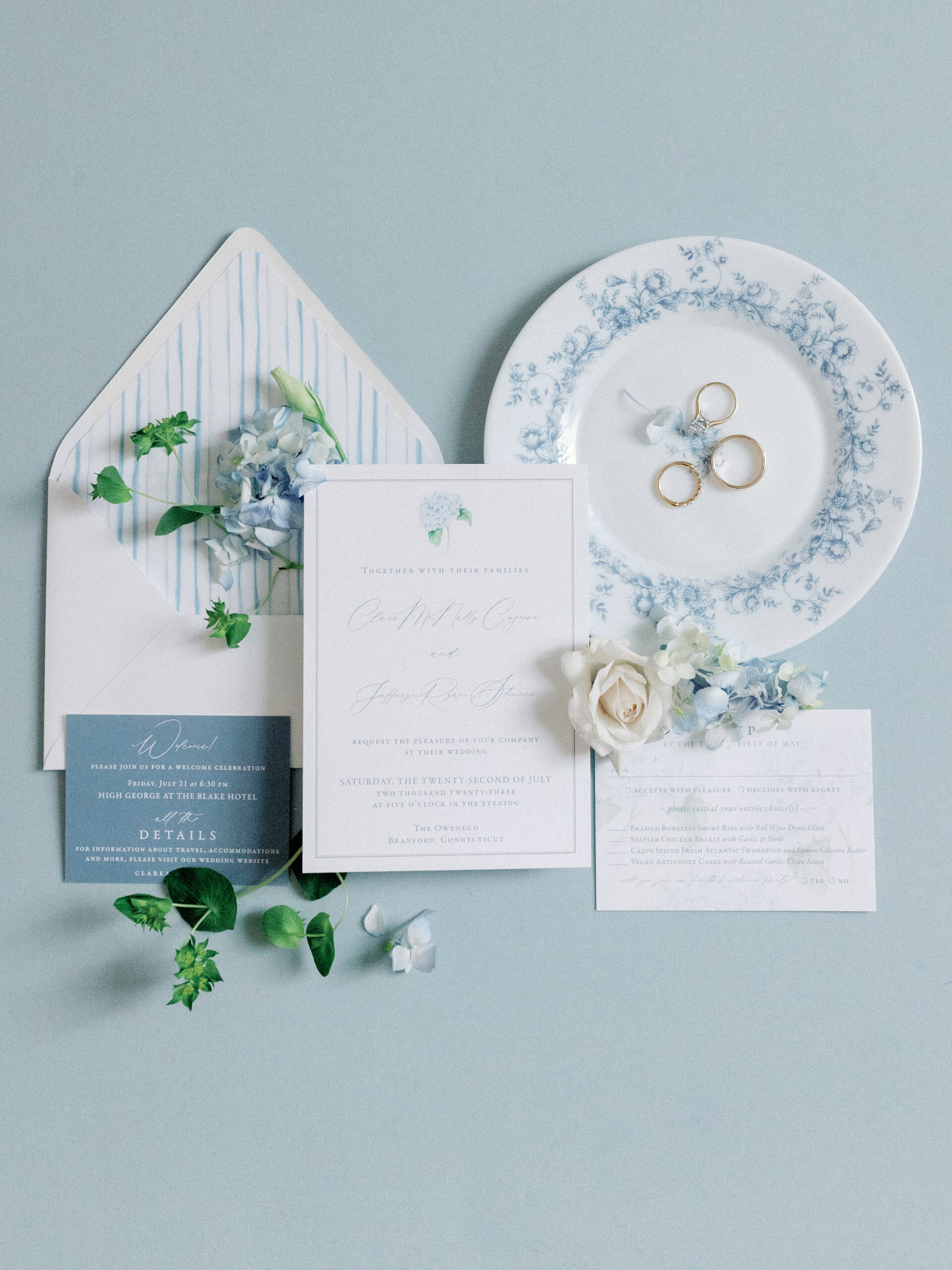 Blue and white stationary with florals on a light blue backdrop