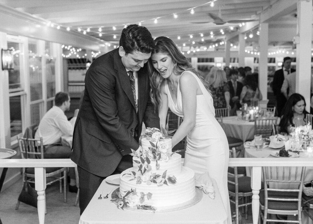 the bride and groom cutting their wedding cake 