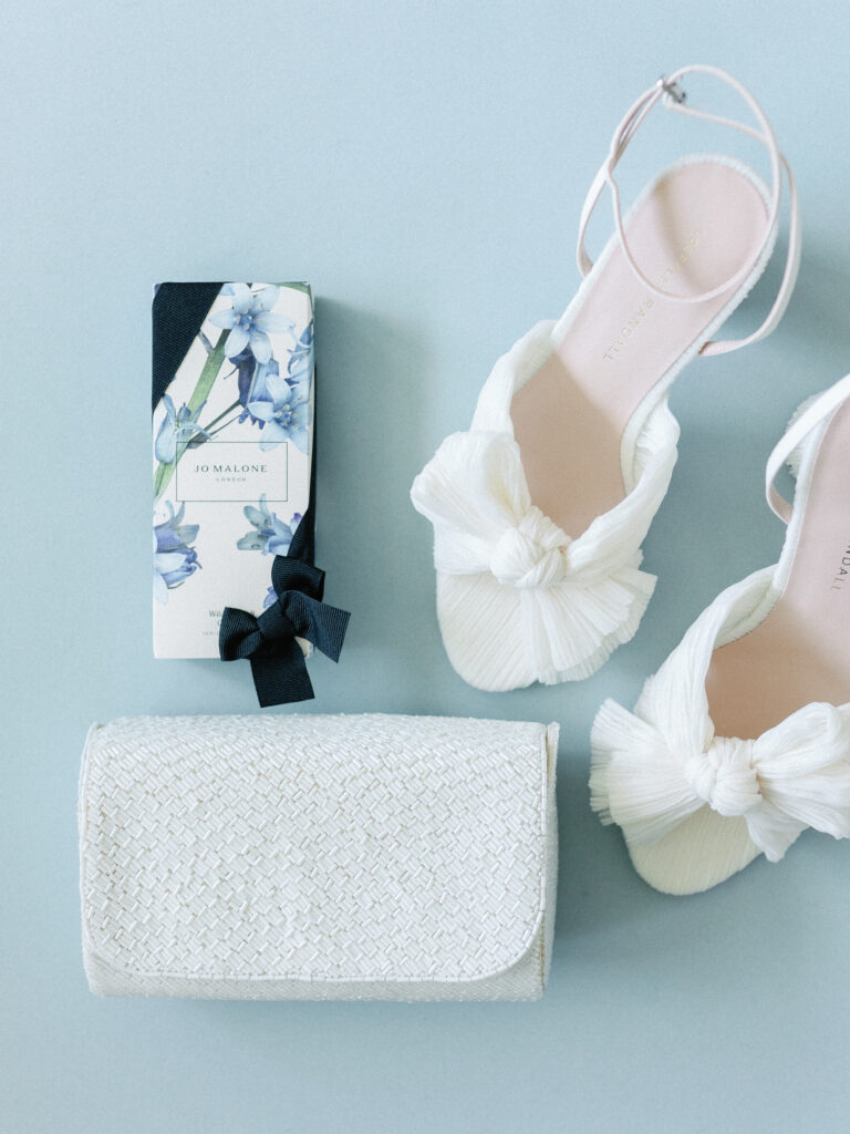 Jo Malone perfume, white bridal shoes and a clutch bag