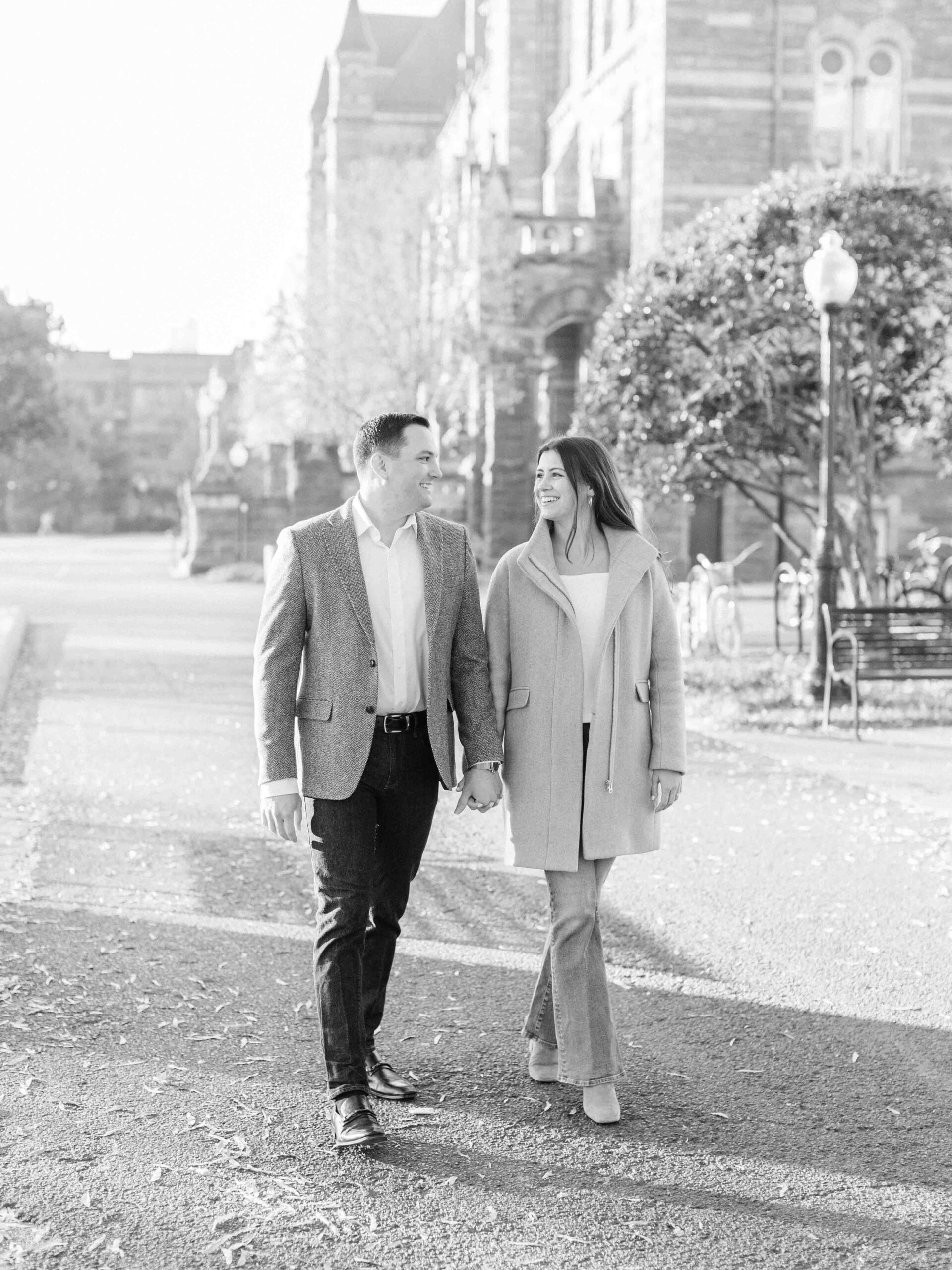 A black and white photo of a couple walking around Georgetown University